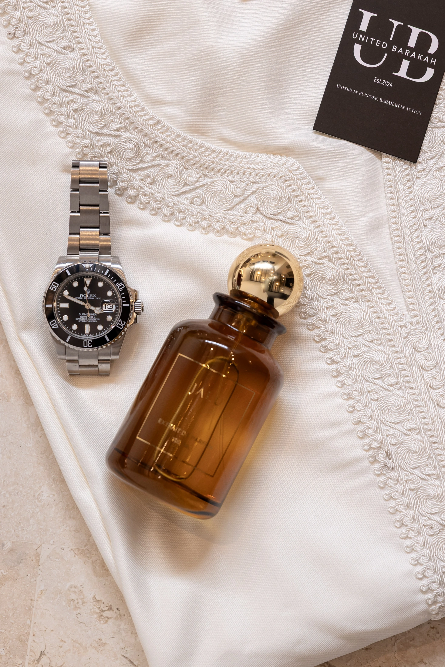 United Barakah embroidered white garment with watch, fragrance and brand tag